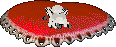 Saria, a small white dog in Petz, lies on a red heart-shaped pillow.