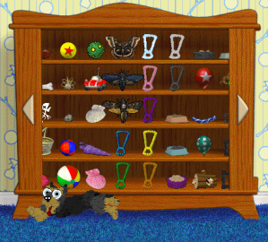 A black and tan Yorkie in Petz runs in front of a wooden cabinet filled with toys.