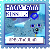A blue dog with a blue pentagon above their head looks at the camera against a background of an icy plain. The text reads 'Hydrargyry Kennelz' at the top and 'Spectacular...!' at the bottom. The stamp is blue, with blue and grey text.