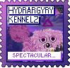 A purple dog with a purple triangle above their head looks at the camera against a background of mountains. The text reads 'Hydrargyry Kennelz' at the top and 'Spectacular...!' at the bottom. The stamp is purple, with blue and purple text.