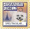 A white dog with a grey circle above their head looks at the camera against a background of clouds. The text reads 'Hydrargyry Kennelz' at the top and 'Spectacular...!' at the bottom. The stamp is yellow, with blue text.